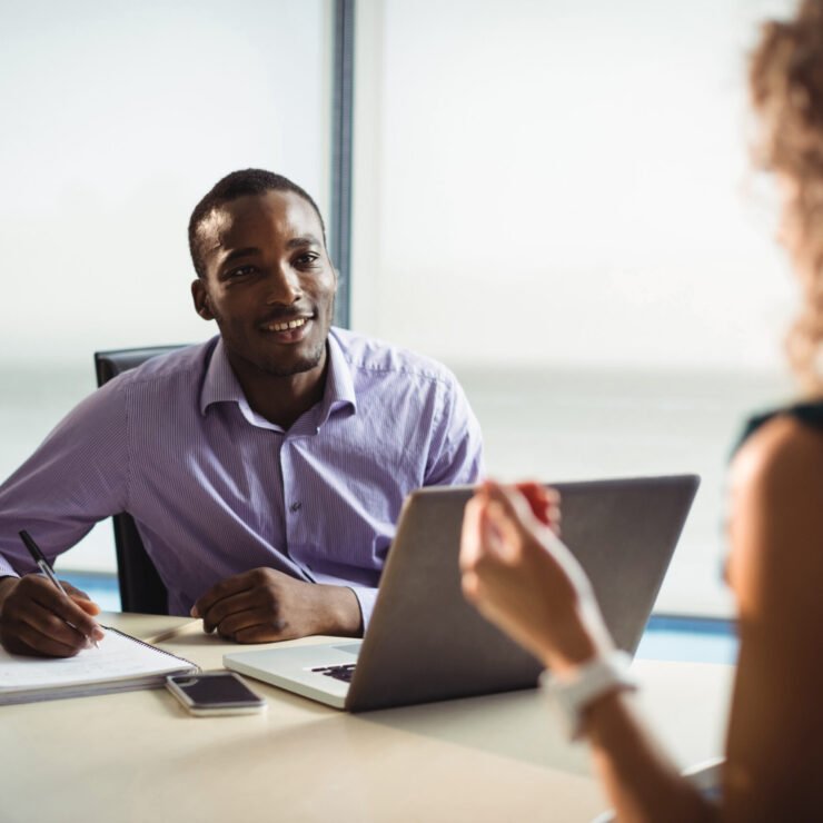 Business executives interacting with each other in office Business executives interacting with each other in office