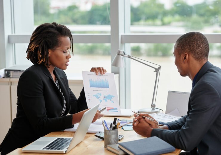 Business woman showing diagram and explaining information to entrepreneur